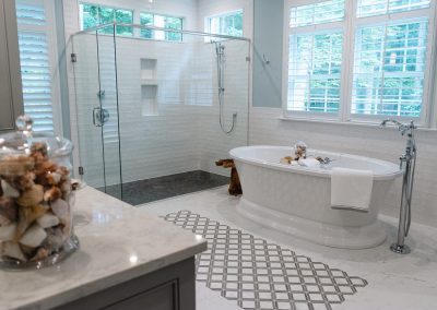 Beautiful glass enclosed walk-in shower and soaker tub